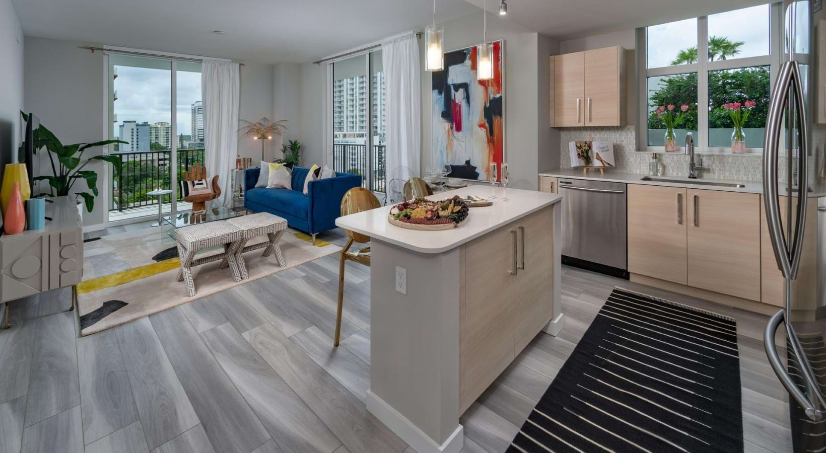 Find your perfect fit at The Rise at Flagler Village a kitchen with a bar and a couch