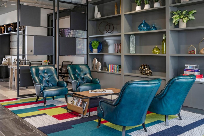 a room with blue chairs and shelves