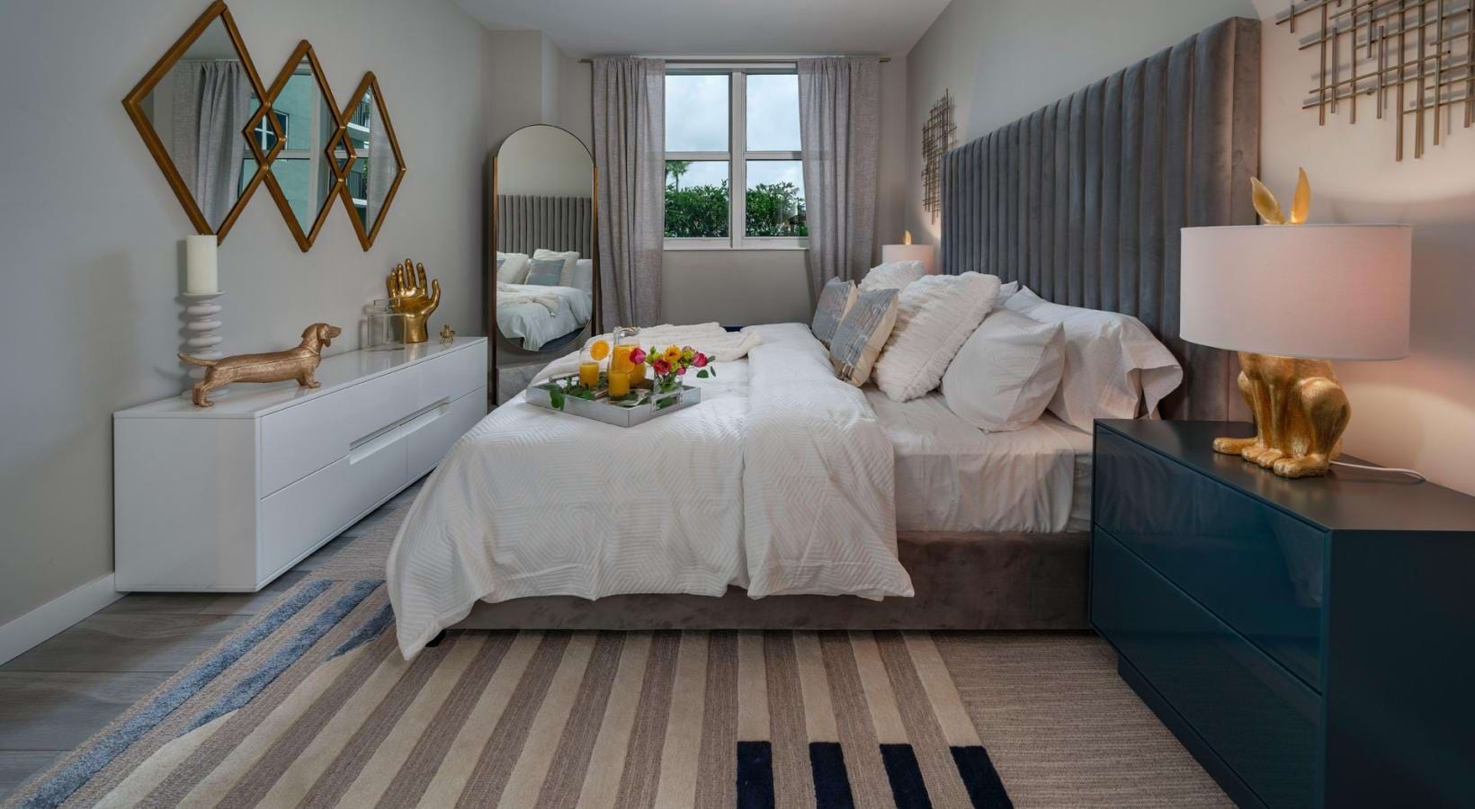 Relax and recharge in beautiful and spacious bedrooms a bedroom with a bed and a mirror